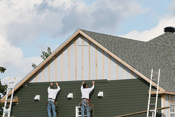 Professional Storm Damage Siding Repair technician working in East Sparta, OH